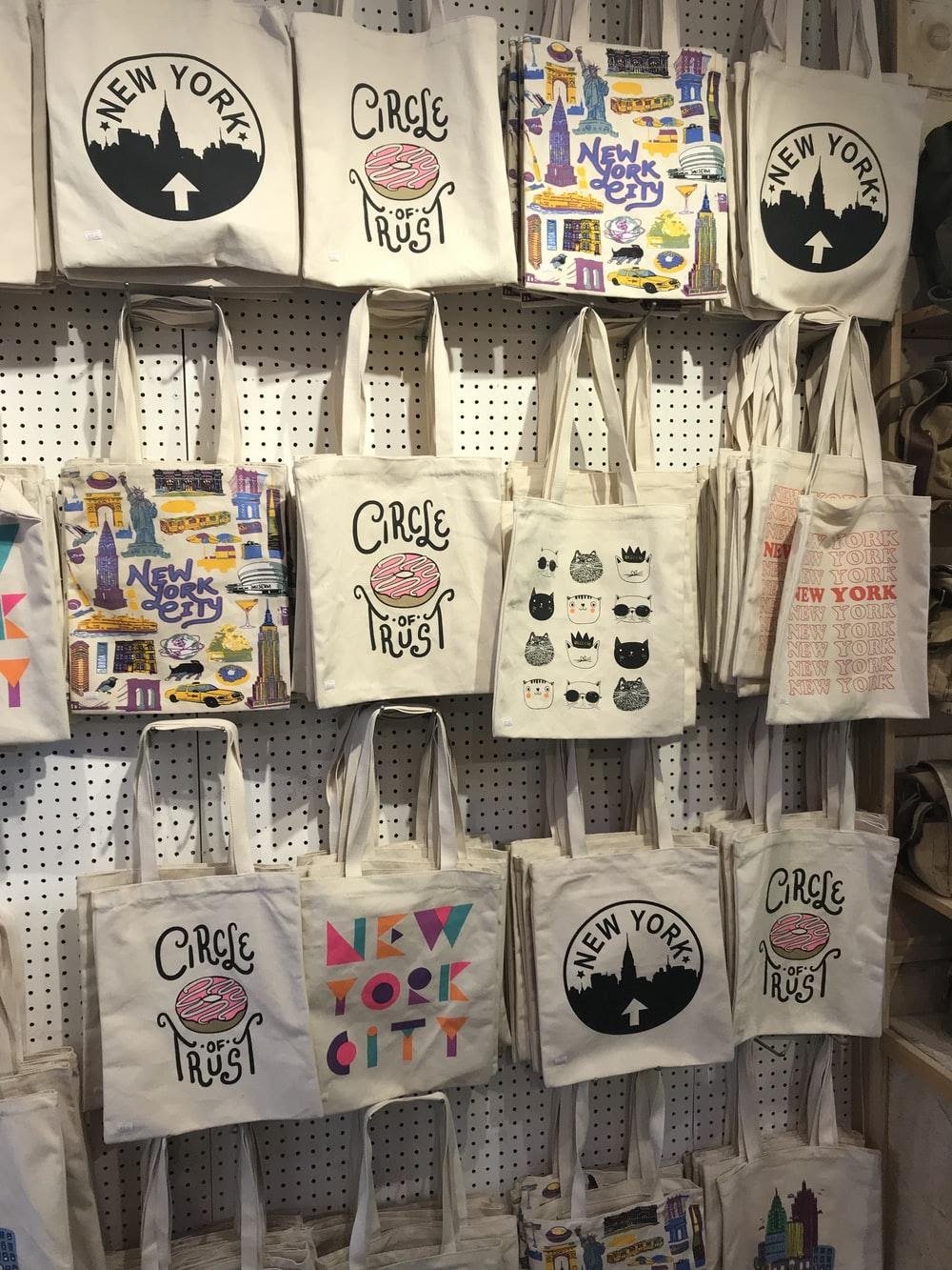A Display of Tote Bags with Different Designs and Words 